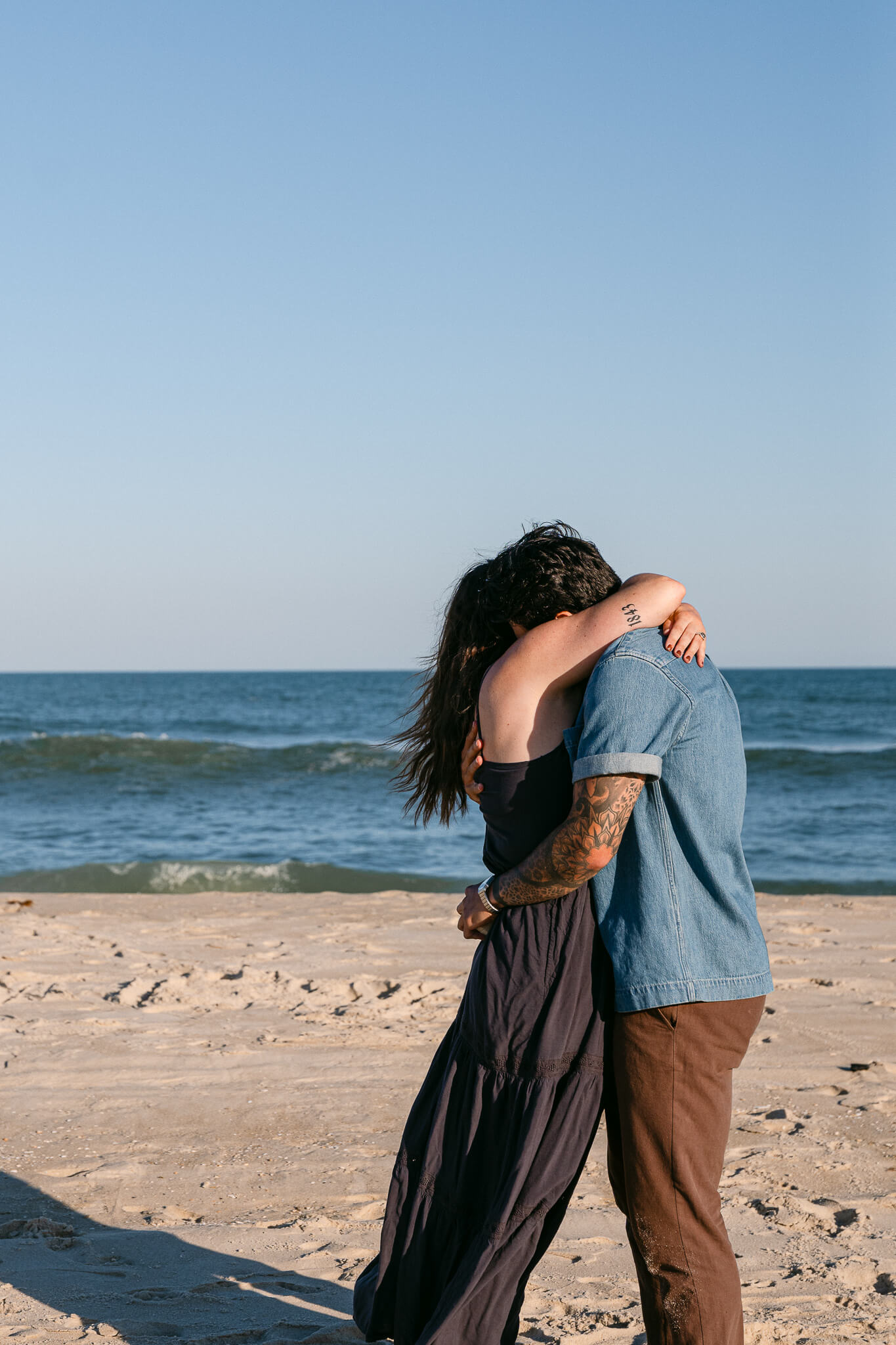 Emotional Engagement session in long beach island with a warm hug embrace