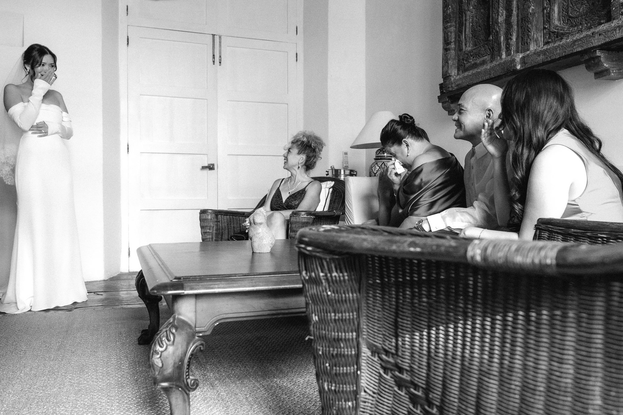 NY bride first look with family showcasing her dress to her mother, best friend, and father