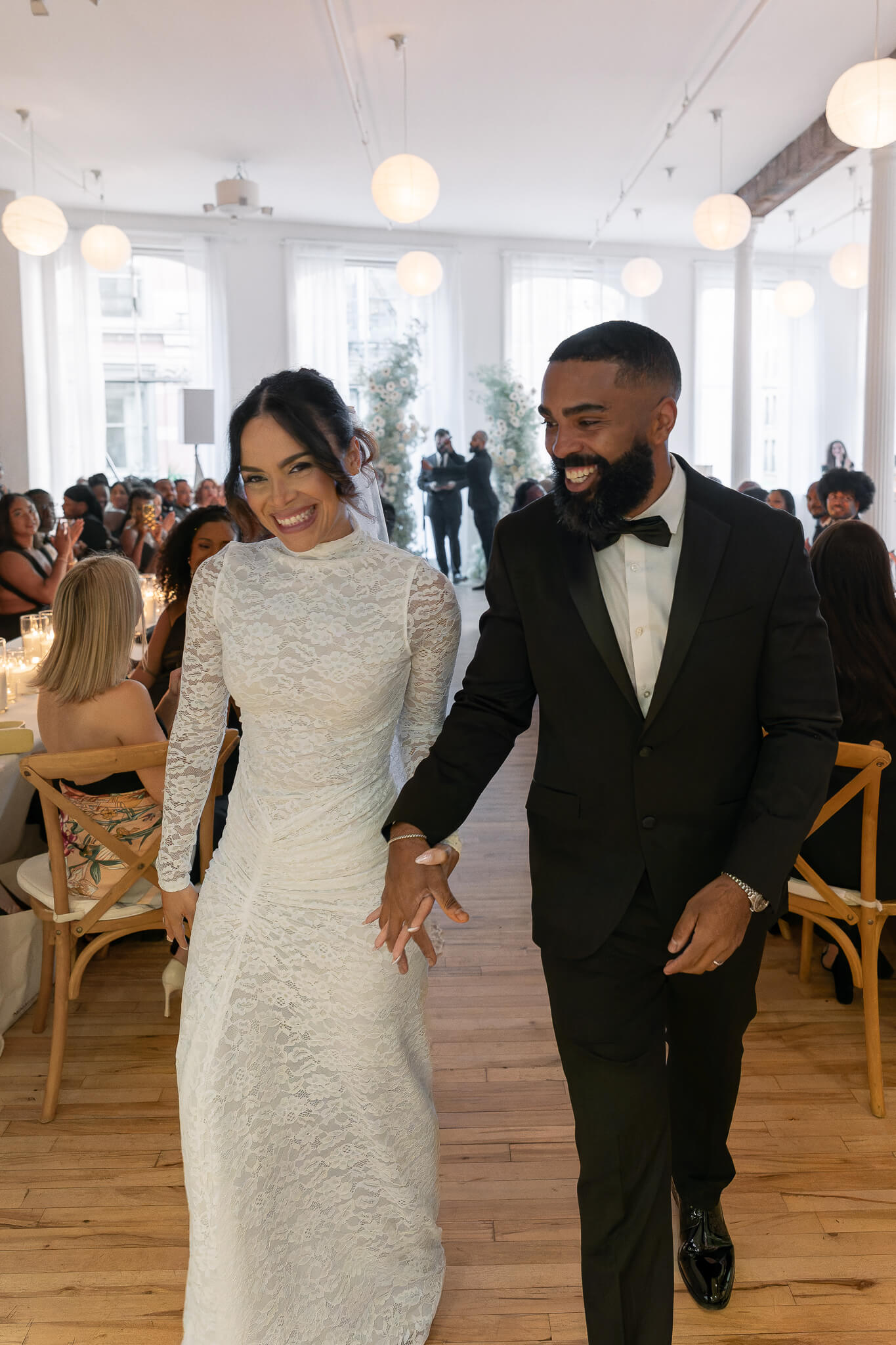 Downtown NYC Wedding couple smiling walking down the aisle located in NYC HOME Studios