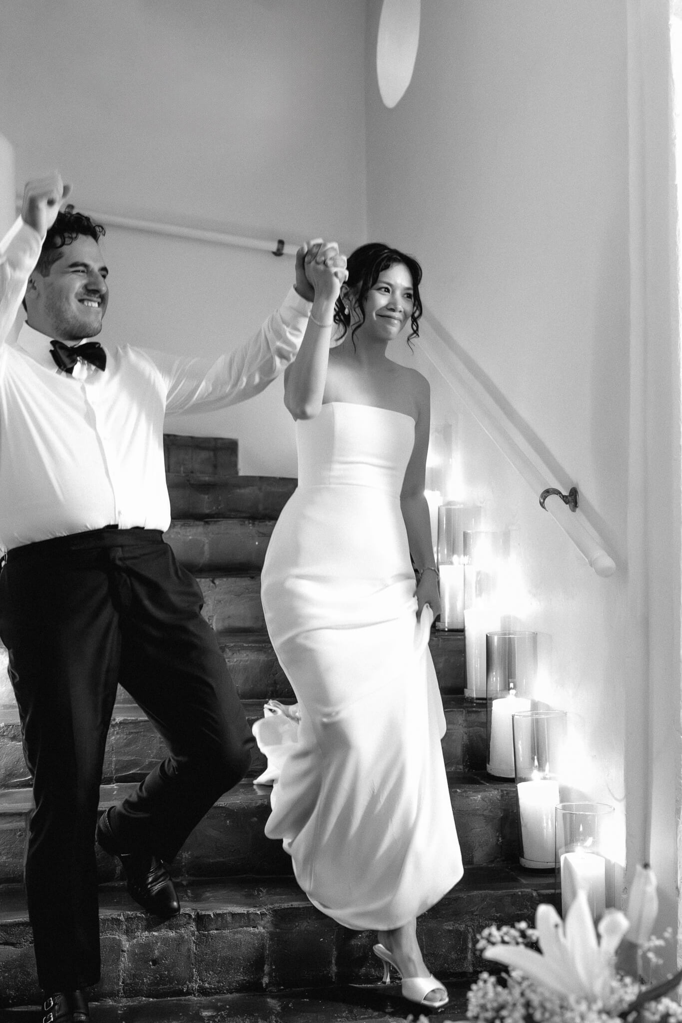 NYC wedding couple wedding cartagena photos coming down stairs to celebrate with wedding guests