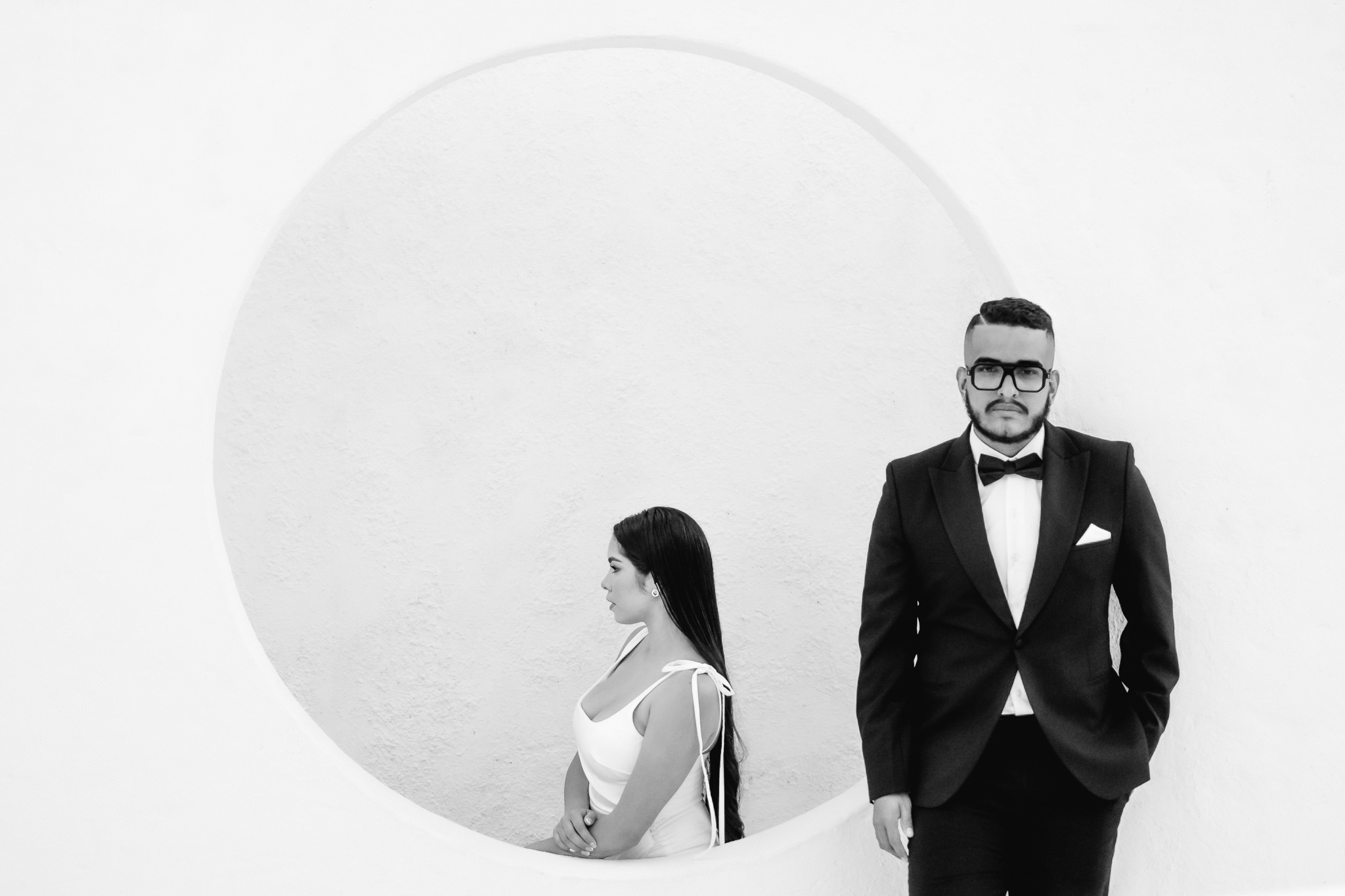 editorial couple portrait posing very serious with the groom looking at the camera and bride looking away