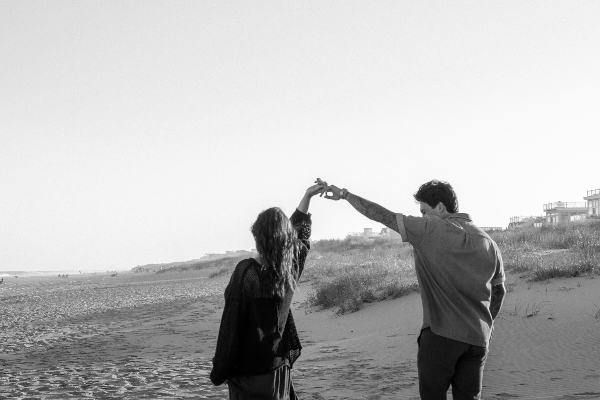 Scenic and whimsical wedding couple with the wind bring the brides vail to cover both and create an intimate moment