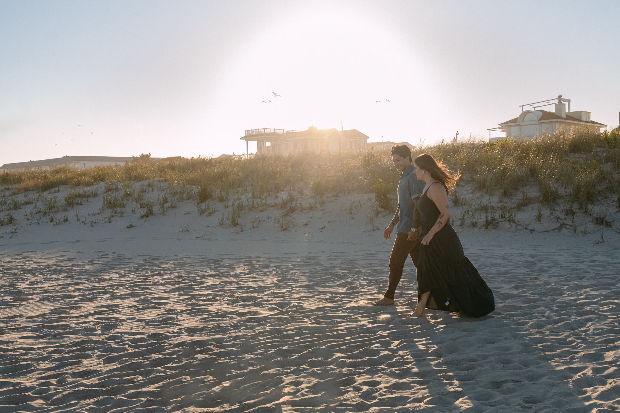 Scenic and whimsical wedding couple with the wind bring the brides vail to cover both and create an intimate moment