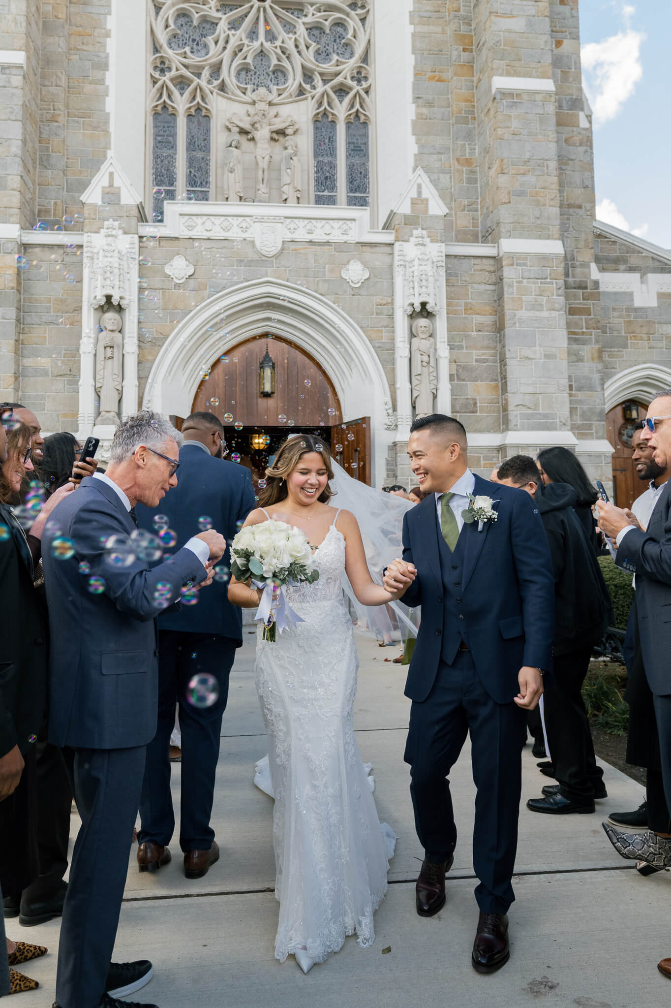 new jersey wedding couple exiting the church after the ceremony and celebrated by their guests